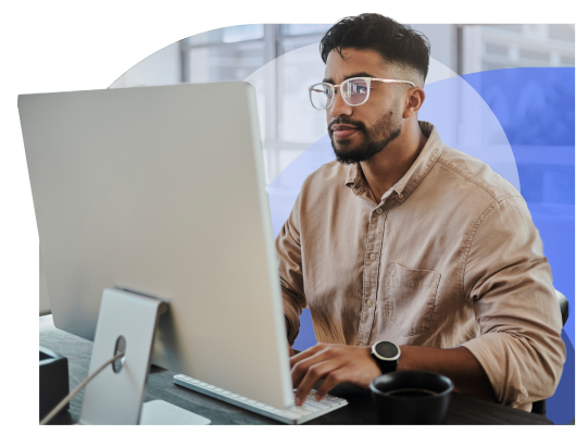 Focused Male Sitting At His Computer Running His Small Business While Using Thryv's Unlimited Support